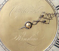 Charles King's name inscribed on a clock face